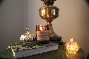 Spiced pumpkin candle on side table