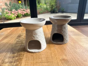 White and grey wax burner on a table